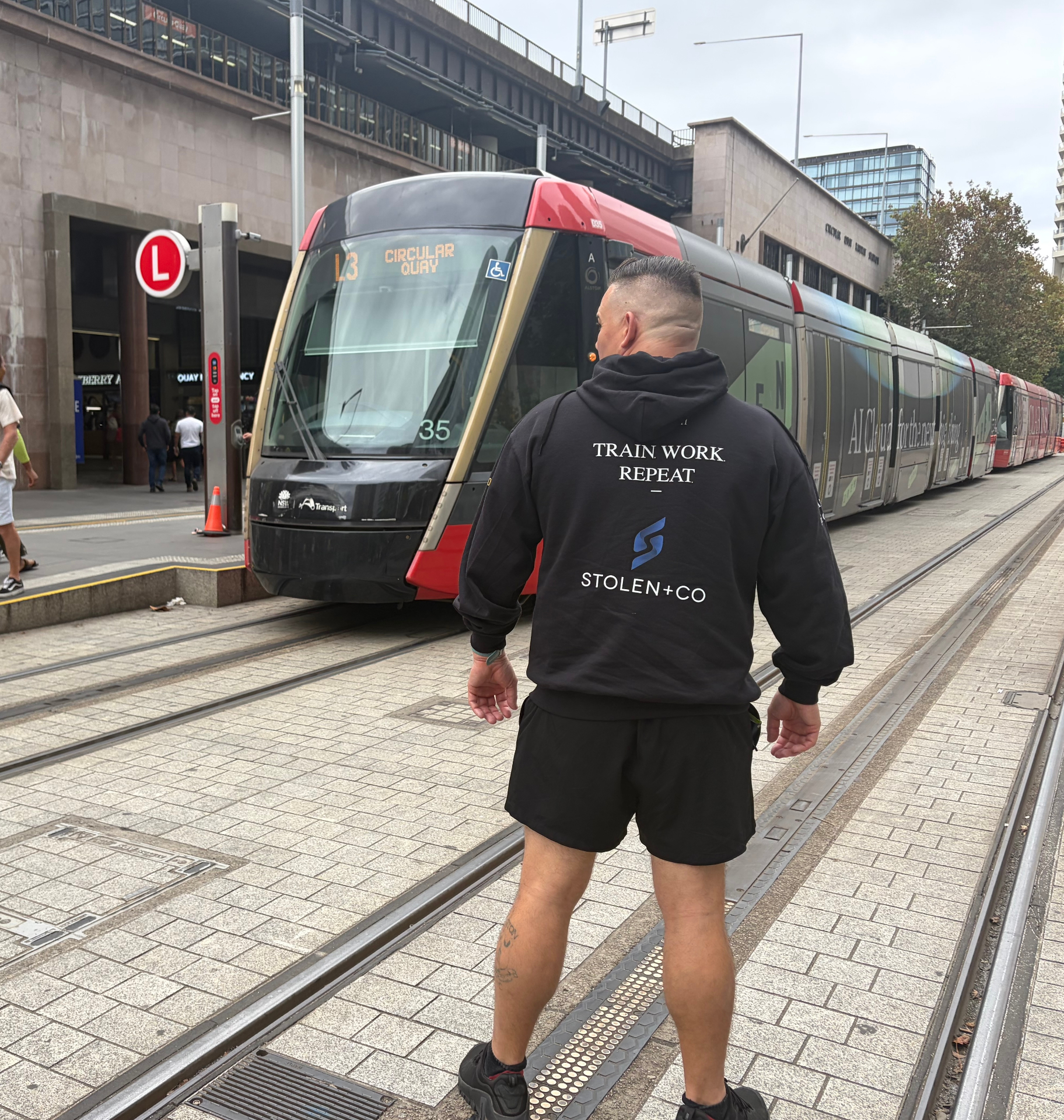 Stolen+Co Train Work Repeat hoodie at Circular Quay tram stop
