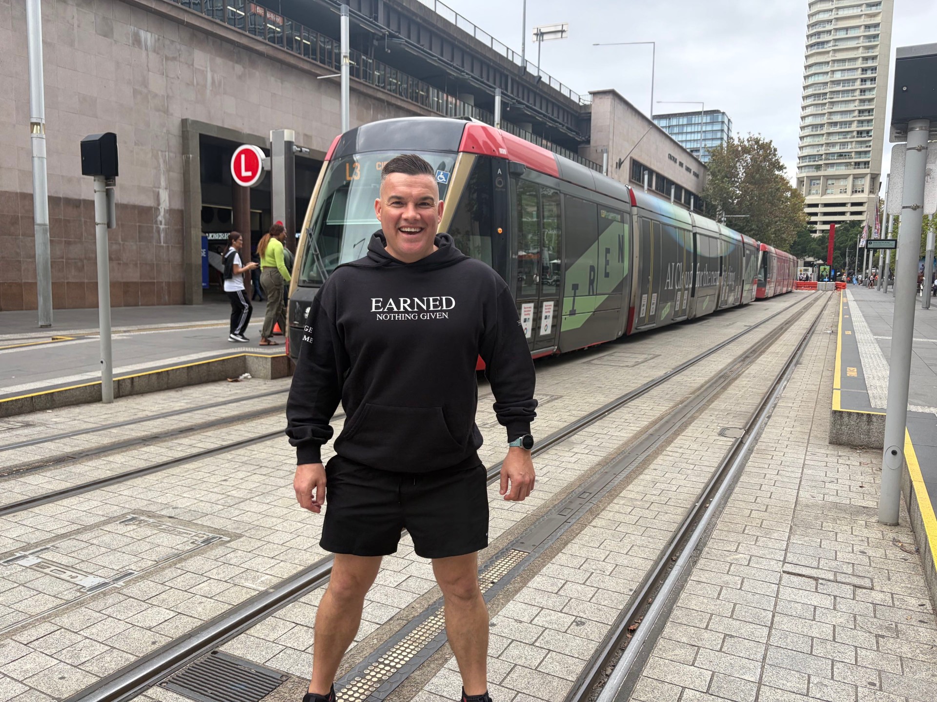 Stolen+Co Train Work Repeat hoodie overlooking the Sydney Opera House