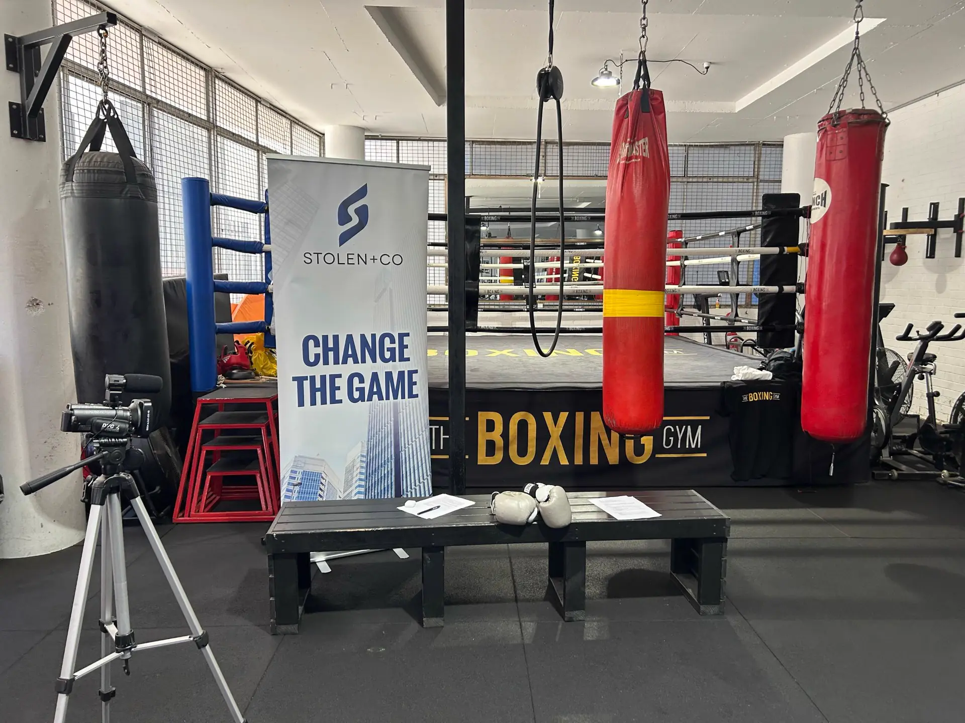 Change the Game podcast set inside a boxing gym with Stolen+Co banner